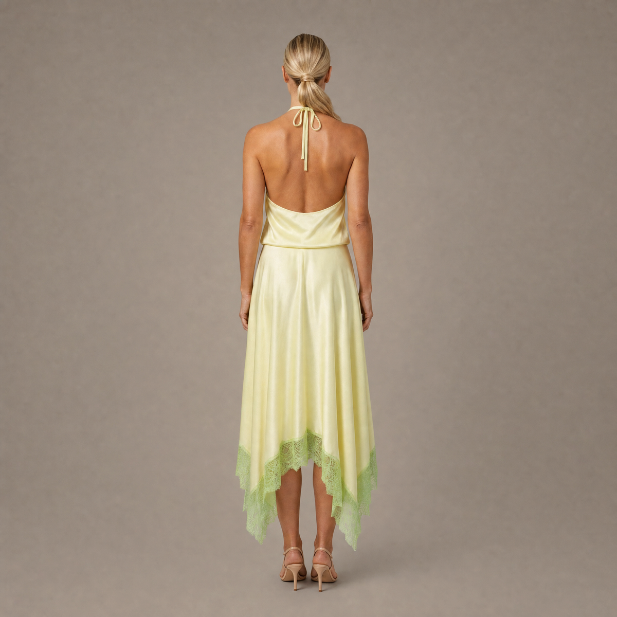 Back view of the key lime backless halter silk maxi dress showing the open back