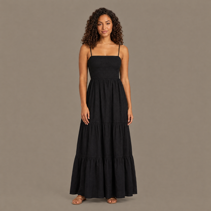 Woman wearing the black backless tiered maxi dress, front view