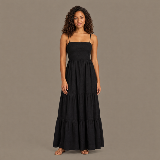 Woman wearing the black backless tiered maxi dress, front view