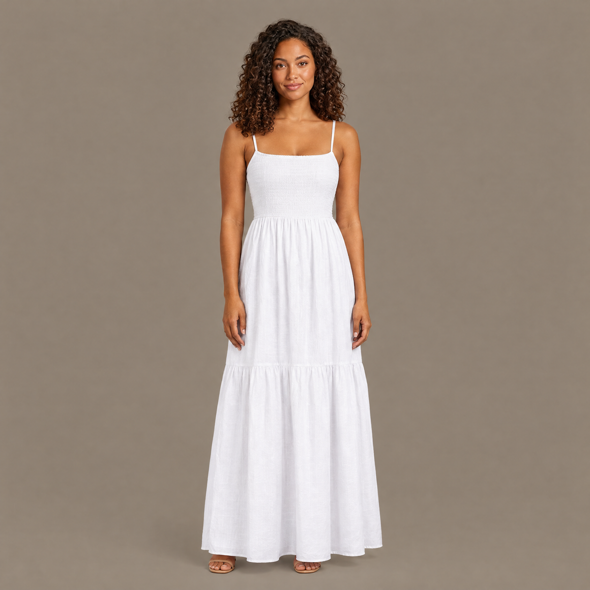 Woman wearing the white backless tiered maxi dress, front view