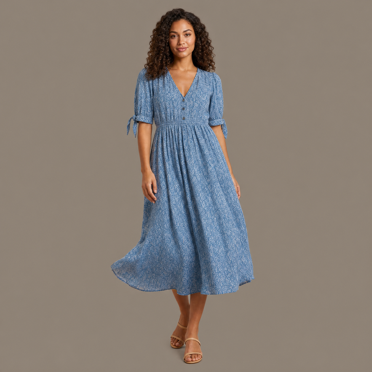 Woman wearing the blue flowing print summer dress, front view