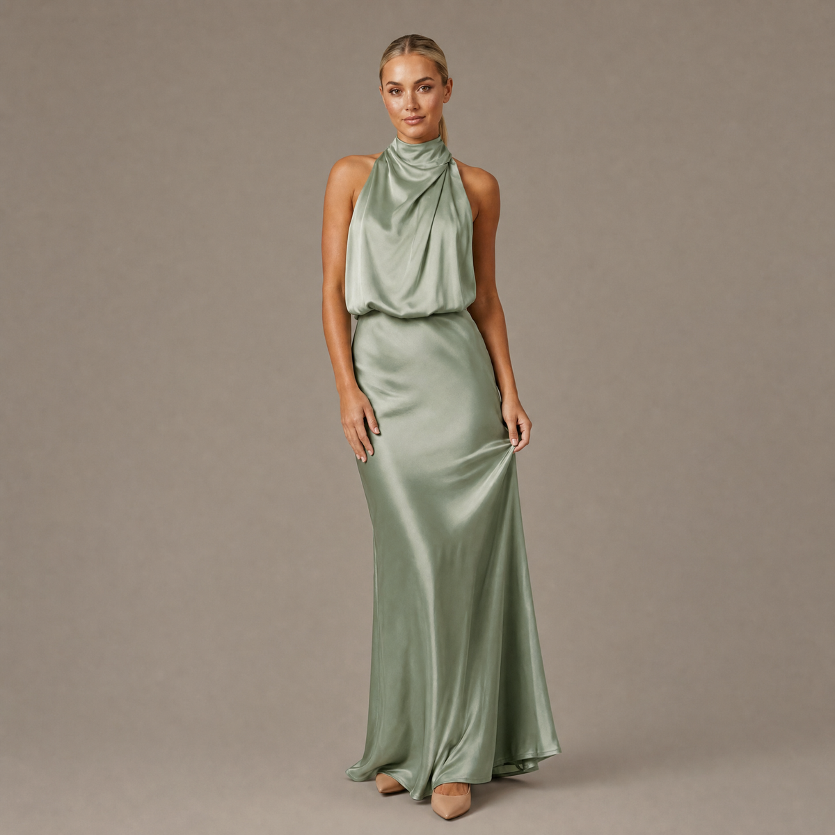 Woman wearing the light green halter neck long satin dress, front view