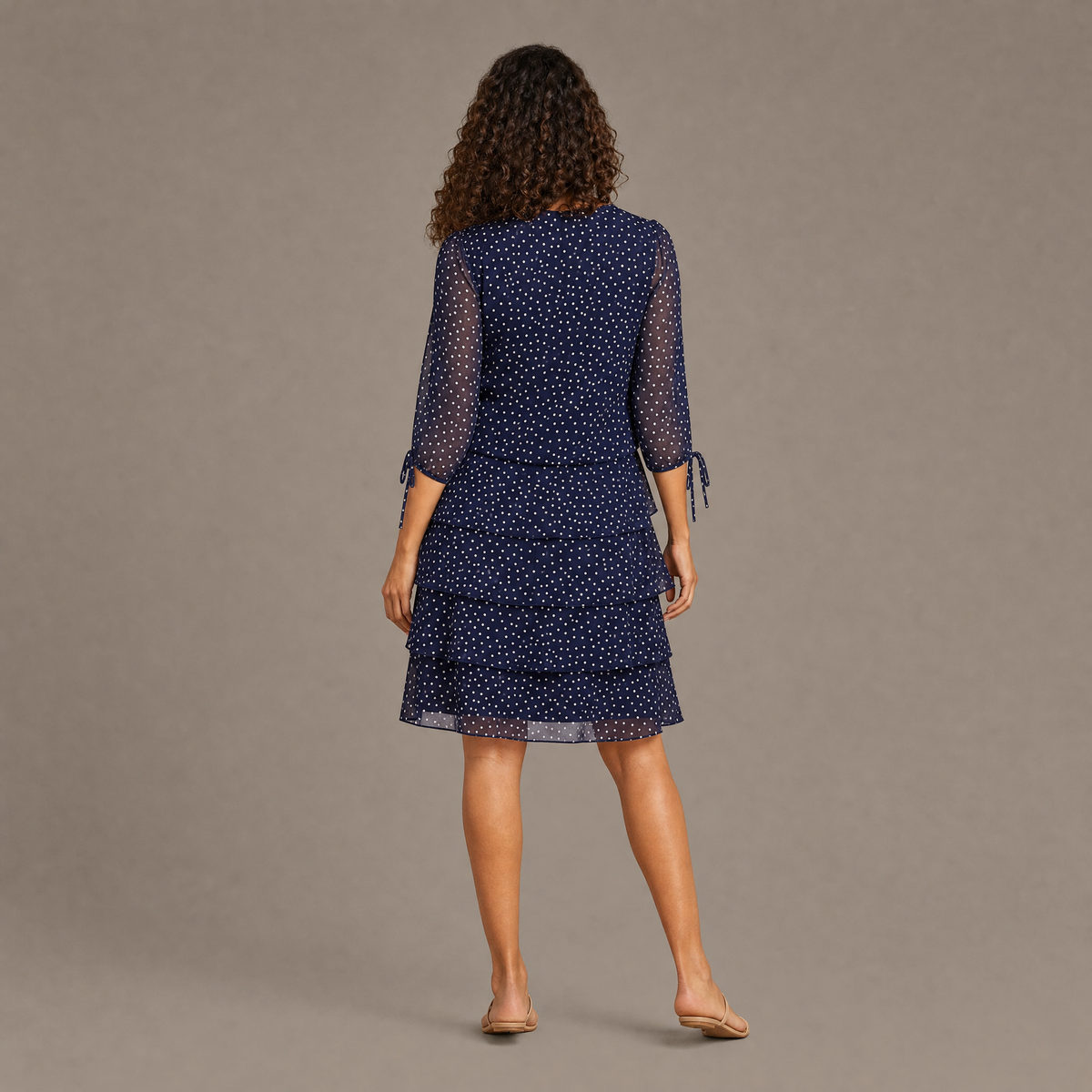 Back view of the navy blue layered polka dot midi dress