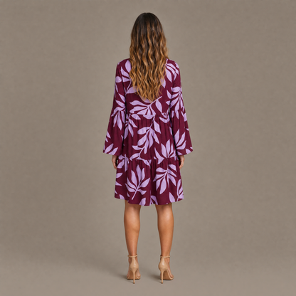Back view of the burgundy leaf print long sleeve tiered mini dress