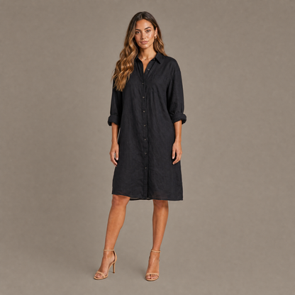 Woman wearing the black oversized linen blend button down shirt dress, front view