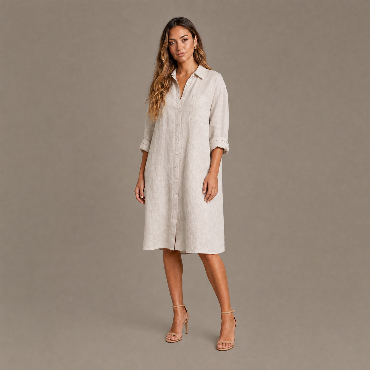 Woman wearing the natural linen oversized button down shirt dress, front view