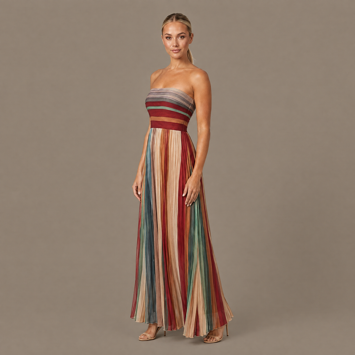 Pleated striped strapless maxi dress seen from a three-quarter angle, showing how the pleats fall