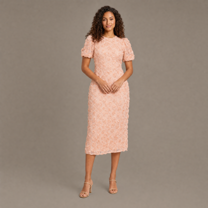 Woman wearing the peach pink puff sleeve floral midi dress, front view