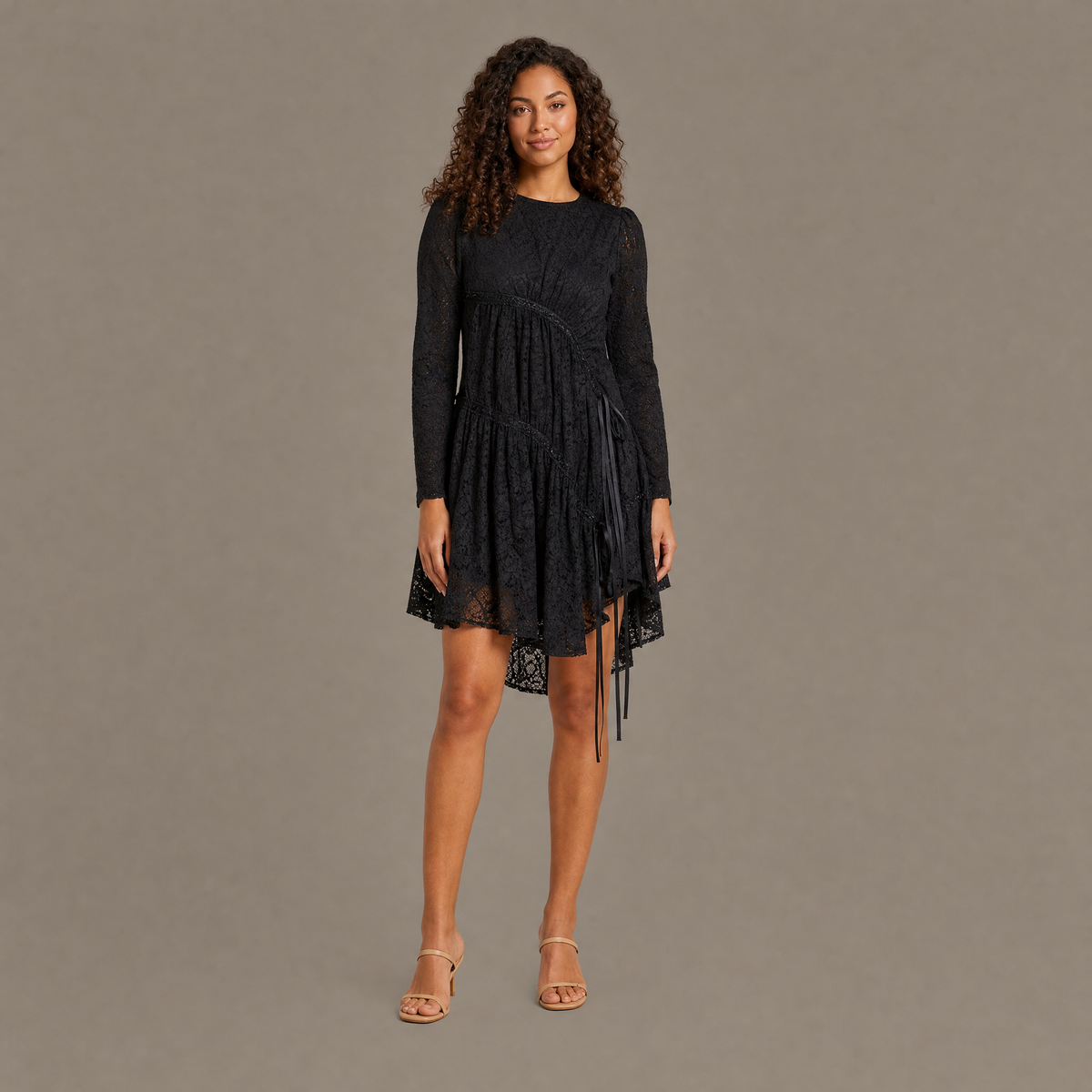 Woman wearing the coal black ruched tiered lace midi dress, front view