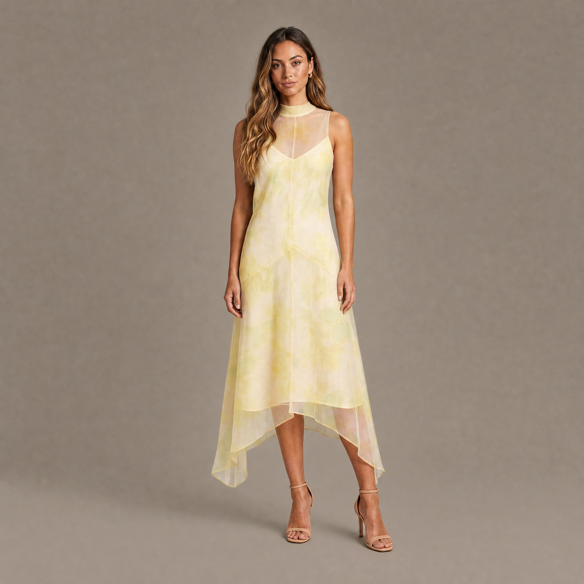Woman wearing the lemon sheer organza overlay high-low midi dress, front view