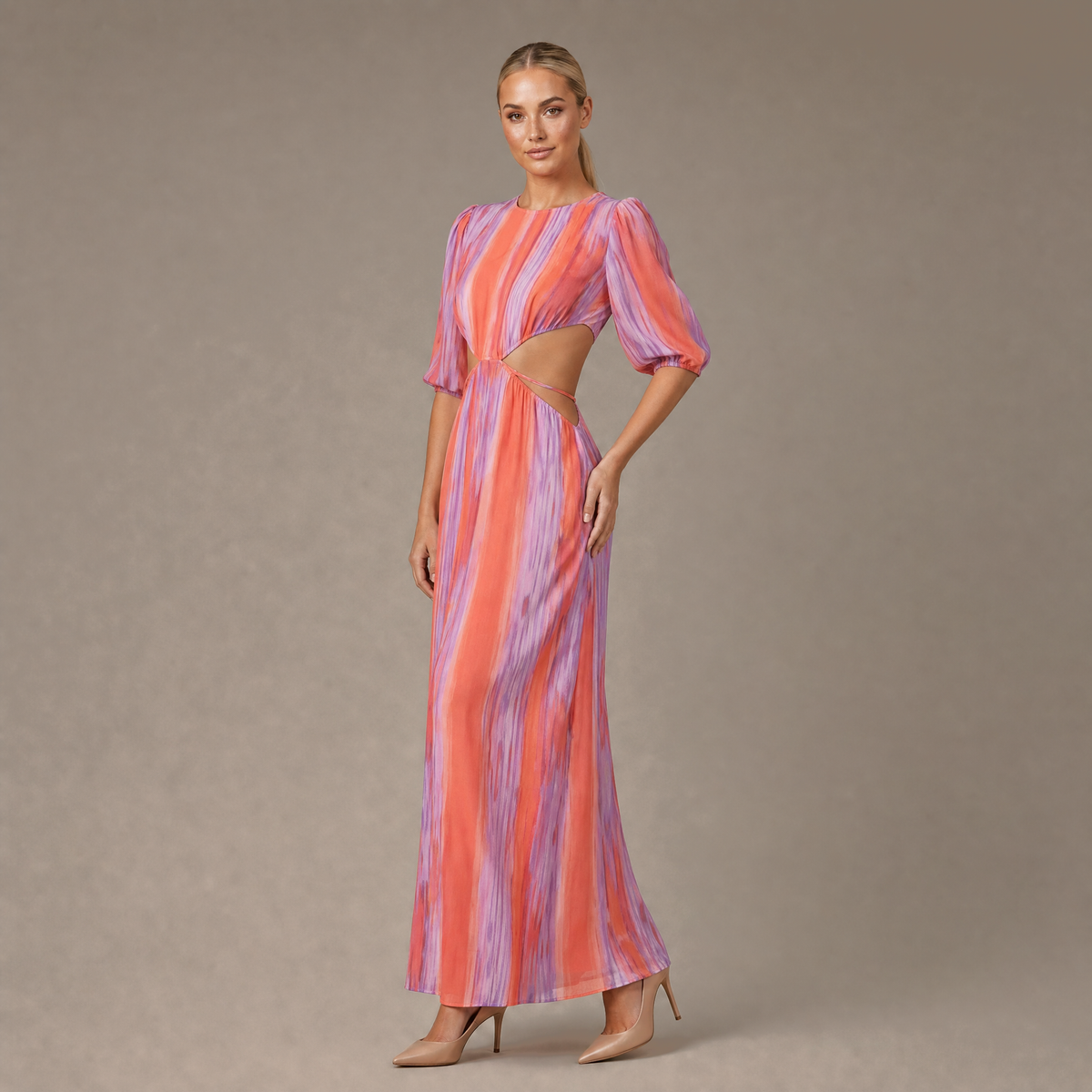 Woman wearing the tie dye dress with side cut outs, front view