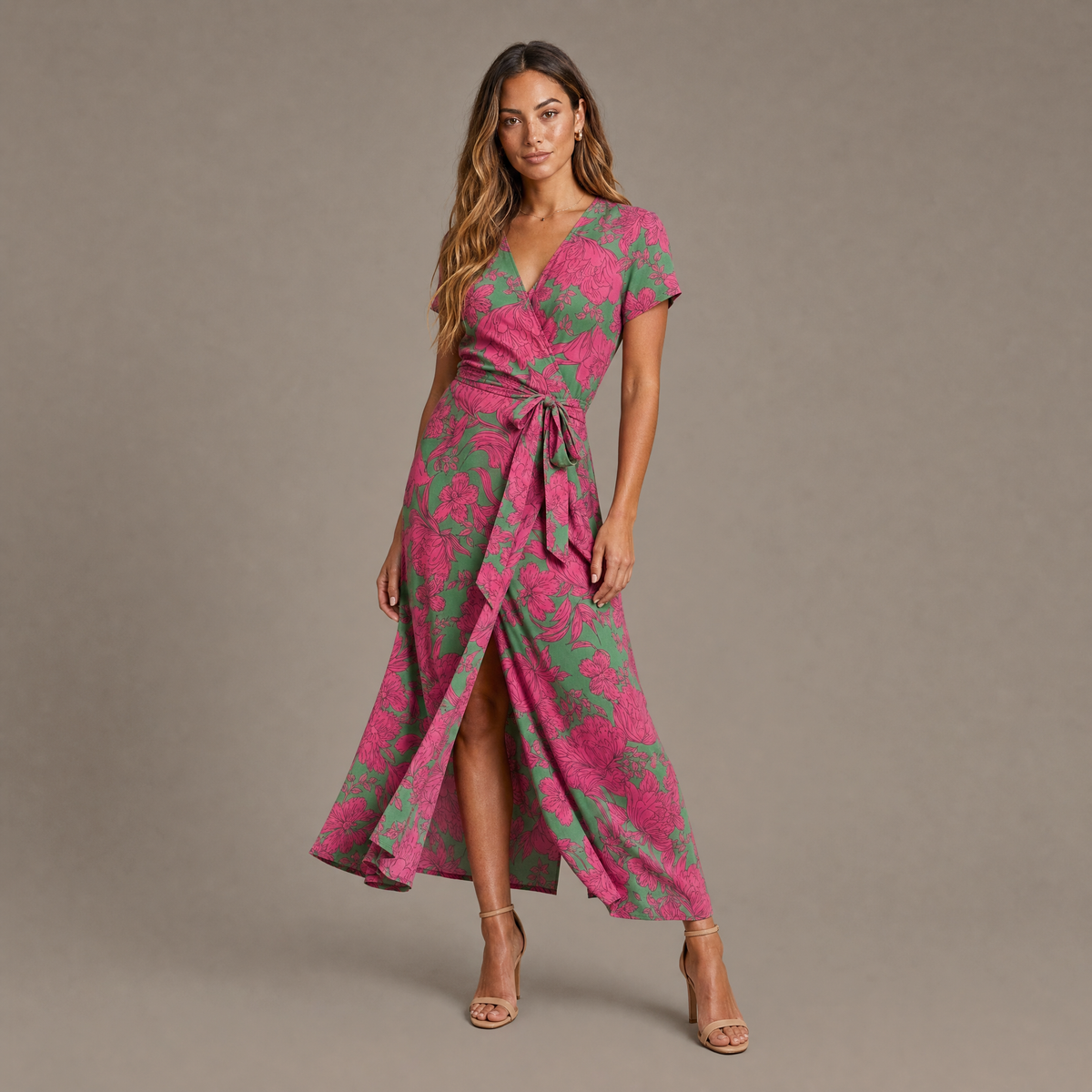 Woman wearing the green and pink soft bloom print wrap dress, front view